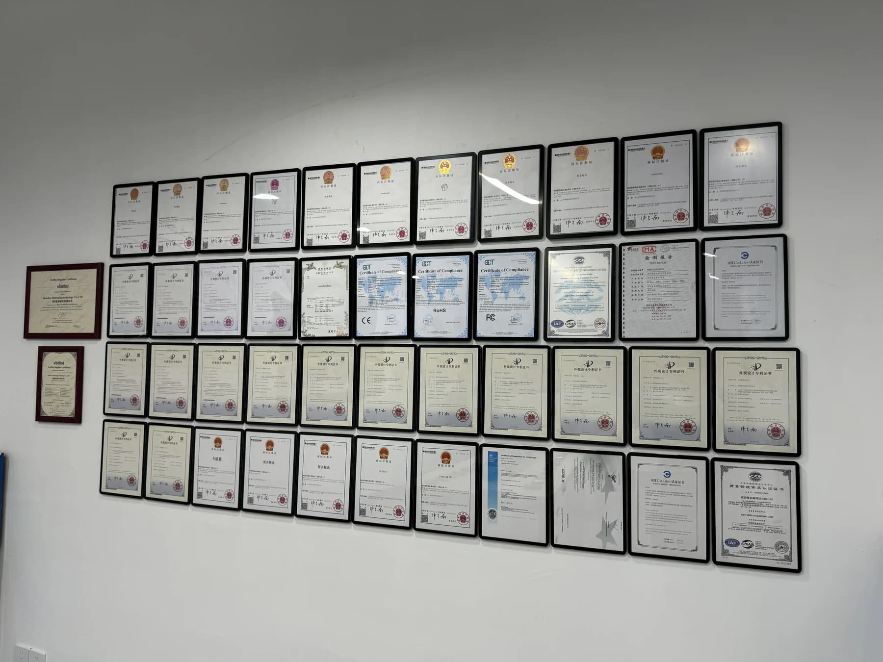 Certificate display wall at the Wooboomagic office